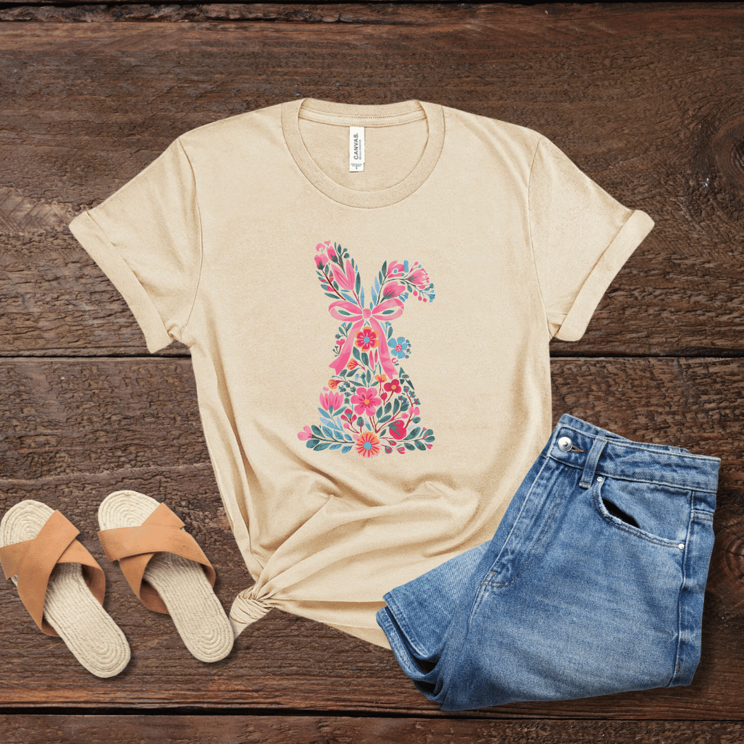 Floral Easter bunny t-shirt in sand on dark wood with jeans & slide sandals
