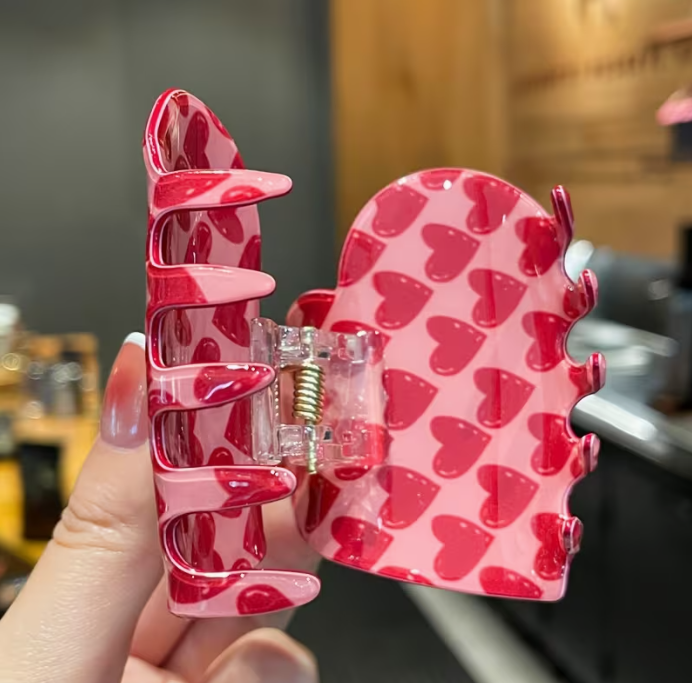 Pink heart hair clip showing strong grip teeth mechanism and red hearts design