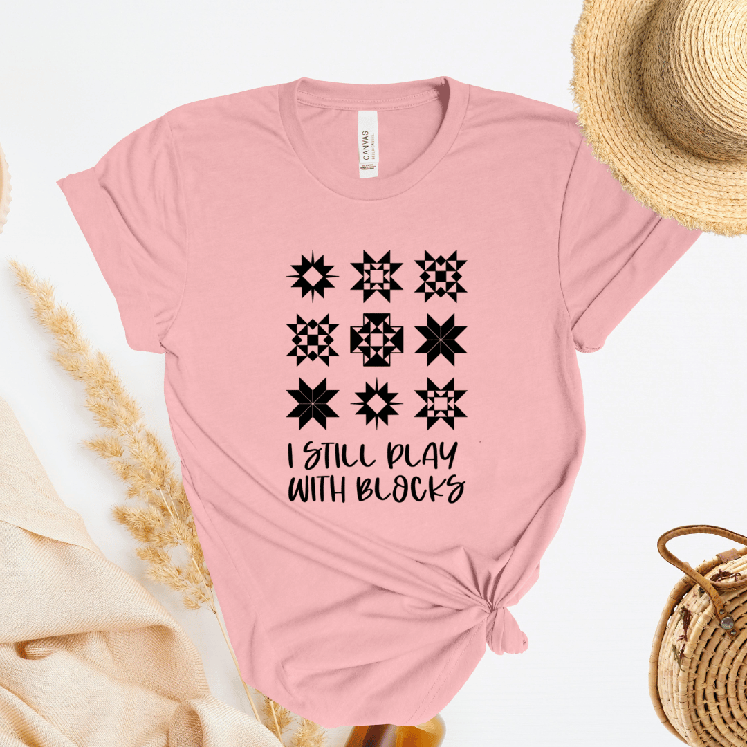 I Still Play With Blocks funny quilting t-shirt in light pink with quilt star block grid design