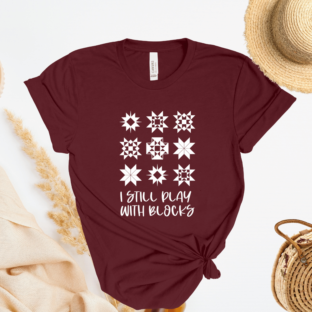 I Still Play With Blocks funny quilting t-shirt in maroon with quilt star block grid design