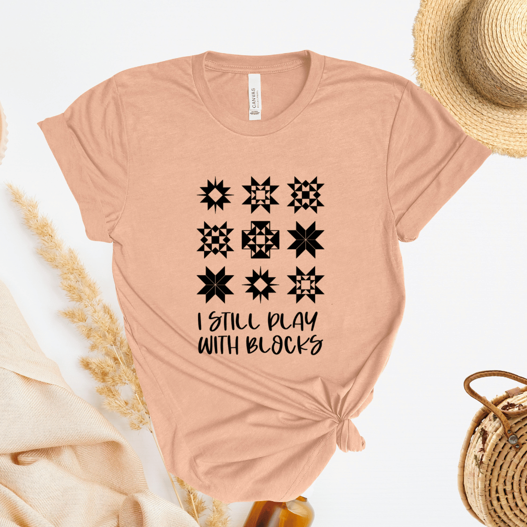 I Still Play With Blocks funny quilting t-shirt in peach color with quilt star block grid design