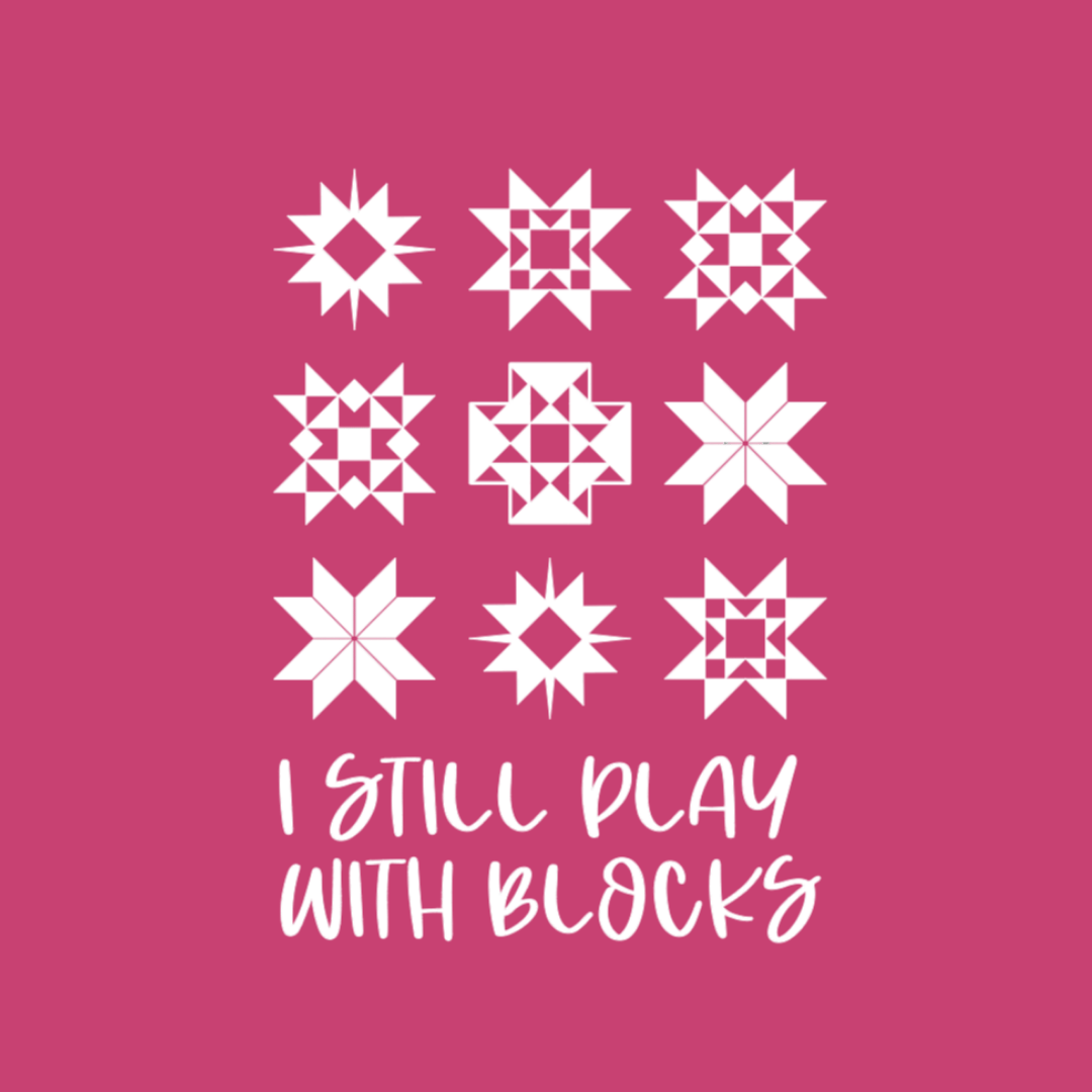I Still Play With Blocks funny quilting graphic on a pink background with quilt star block grid design