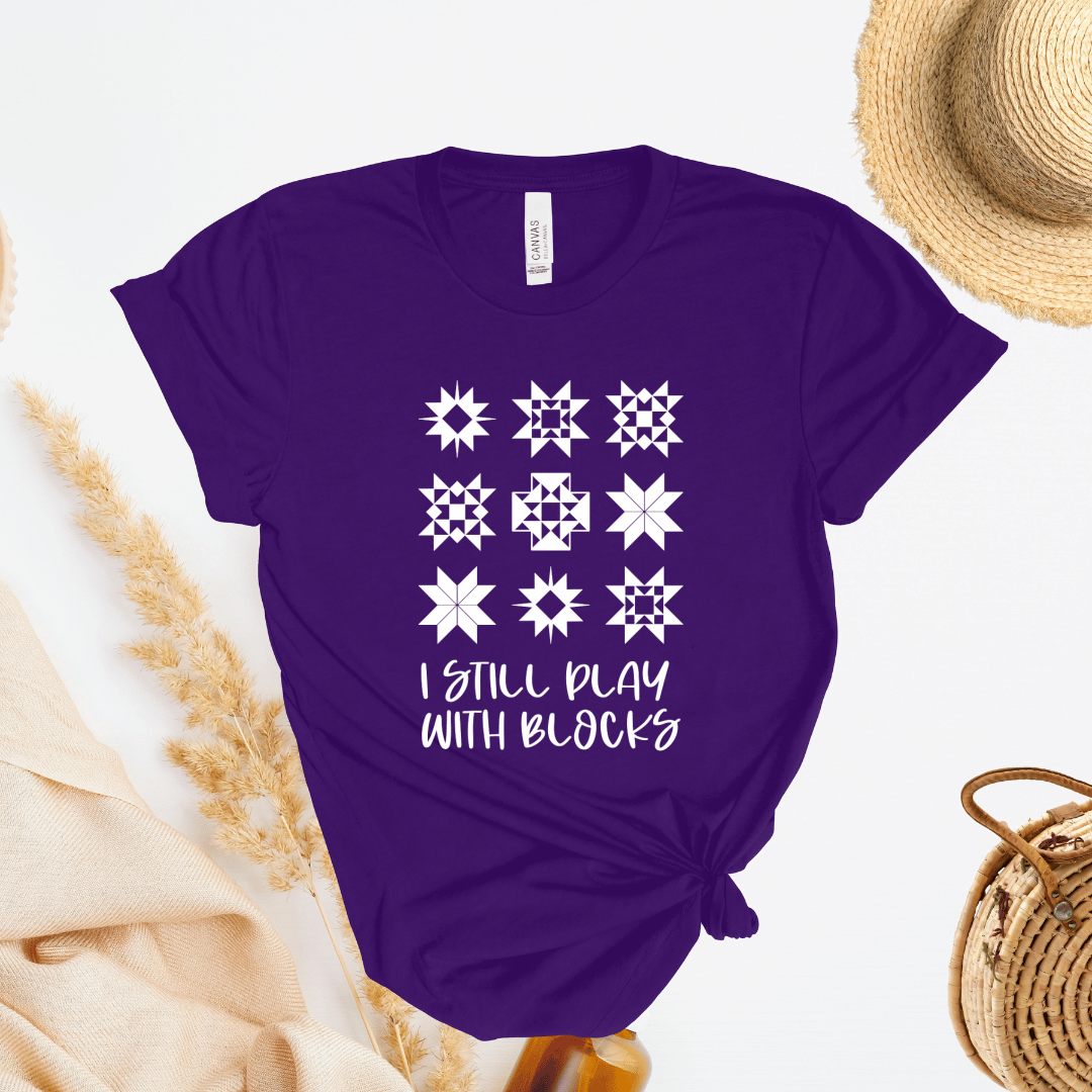 I Still Play With Blocks funny quilting t-shirt in purple with quilt star block grid design