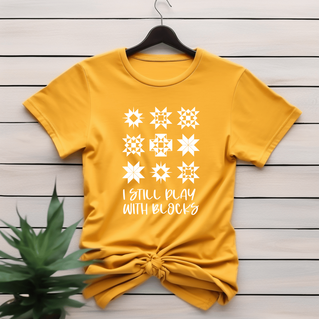 I Still Play With Blocks funny quilting t-shirt in yellow with quilt star block grid design