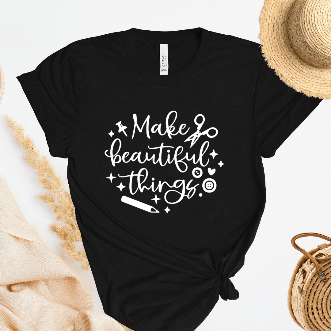 Black t-shirt with 'Make beautiful things' text on a light background