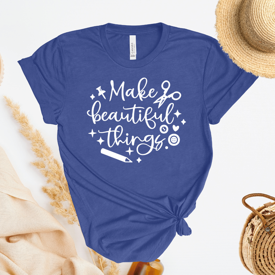 Blue t-shirt with 'Make beautiful things' text on a light background
