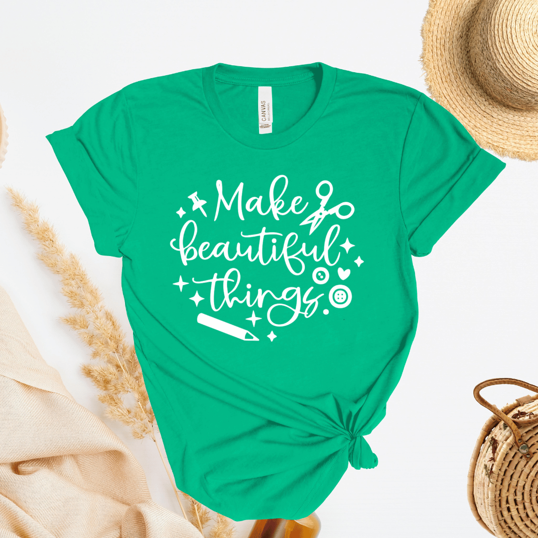 Green t-shirt with 'Make beautiful things' text on a light background