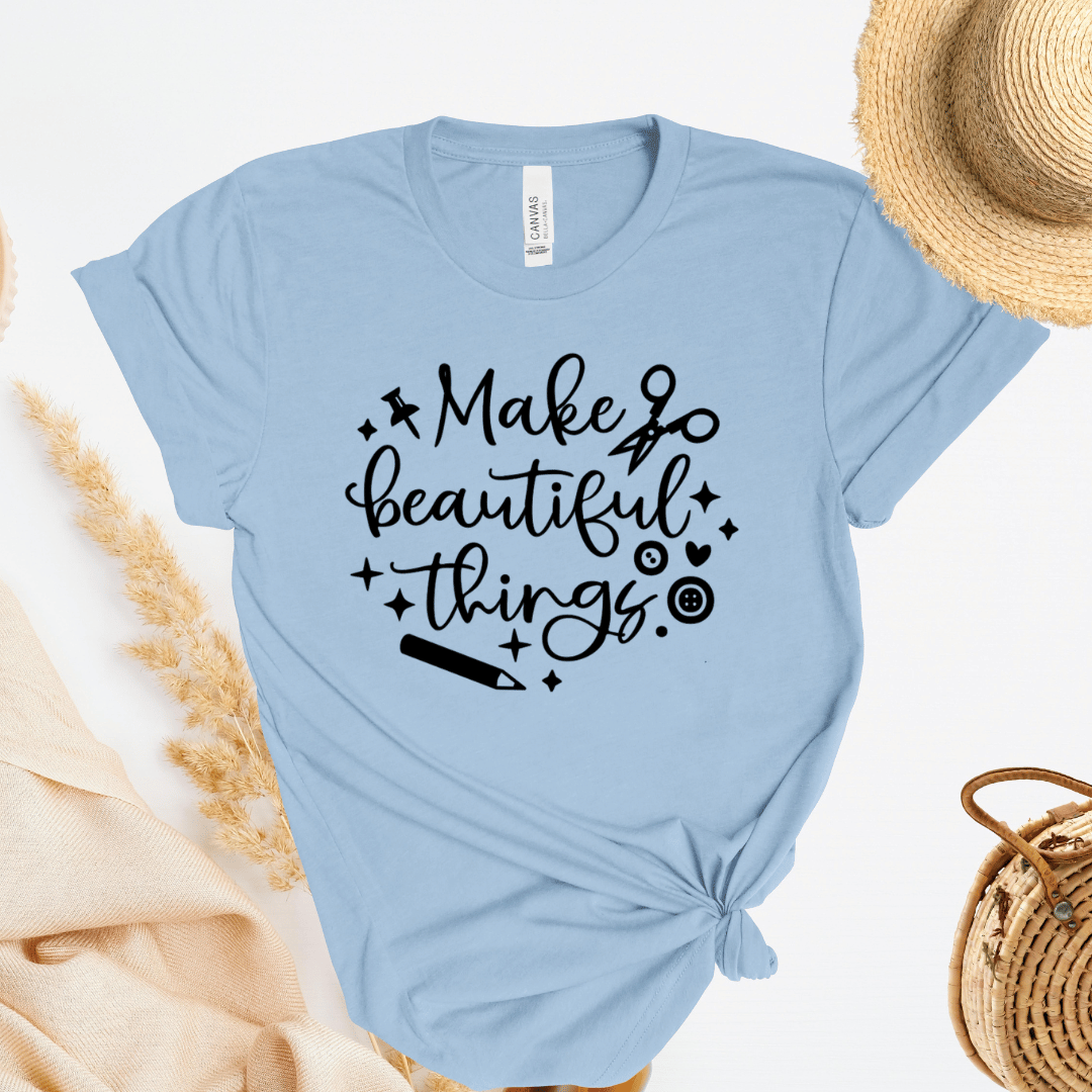 Light blue crafting themed t-shirt with 'Make beautiful things' text on a white background