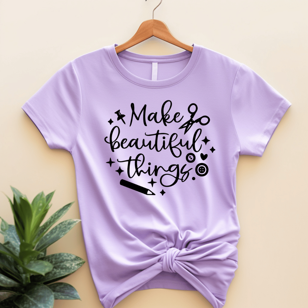 Purple lilac t-shirt with 'Make beautiful things' text on a beige background