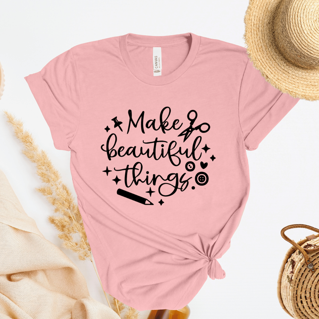 Light pink t-shirt with 'Make beautiful things' text on a light background