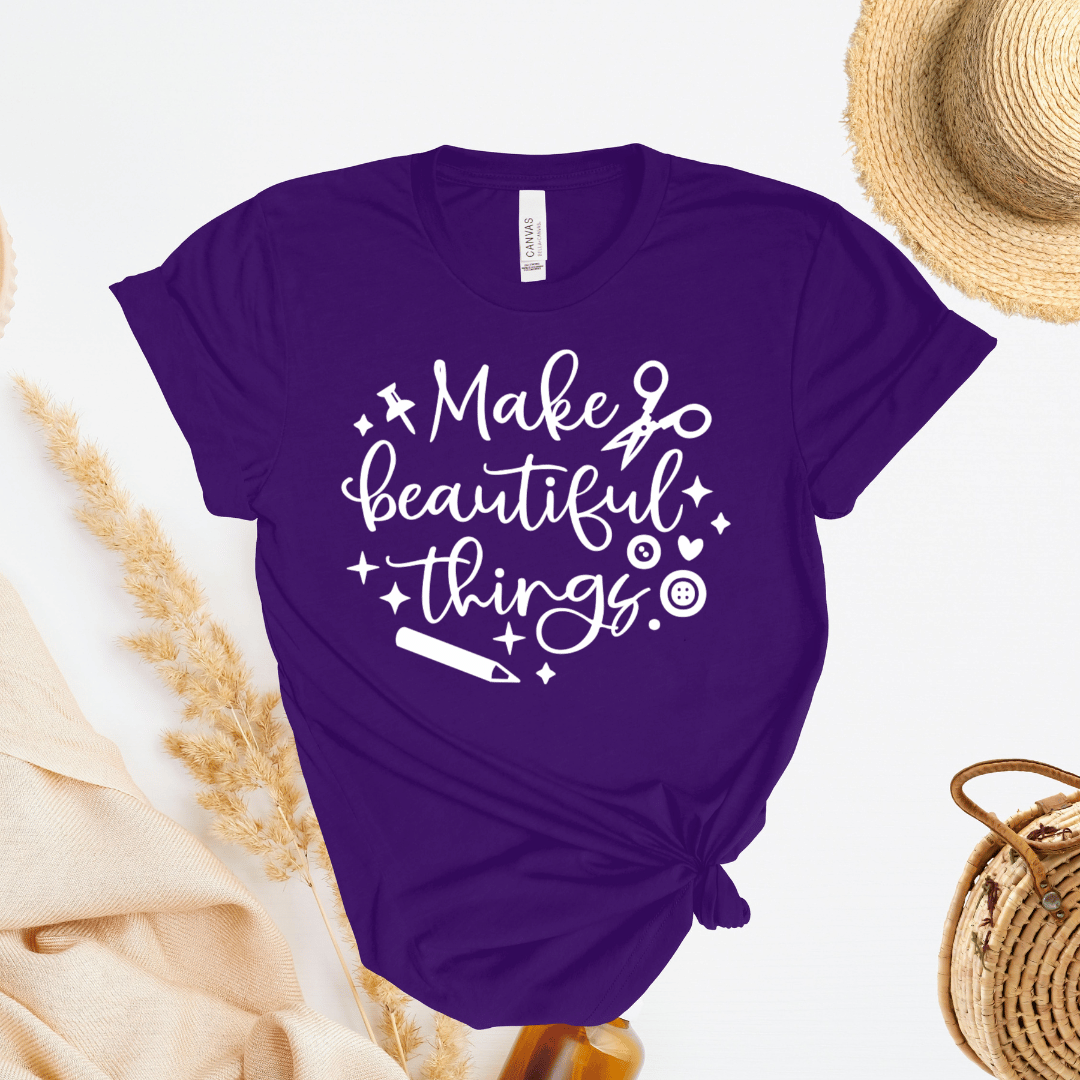 Purple t-shirt with 'Make beautiful things' text on a light background