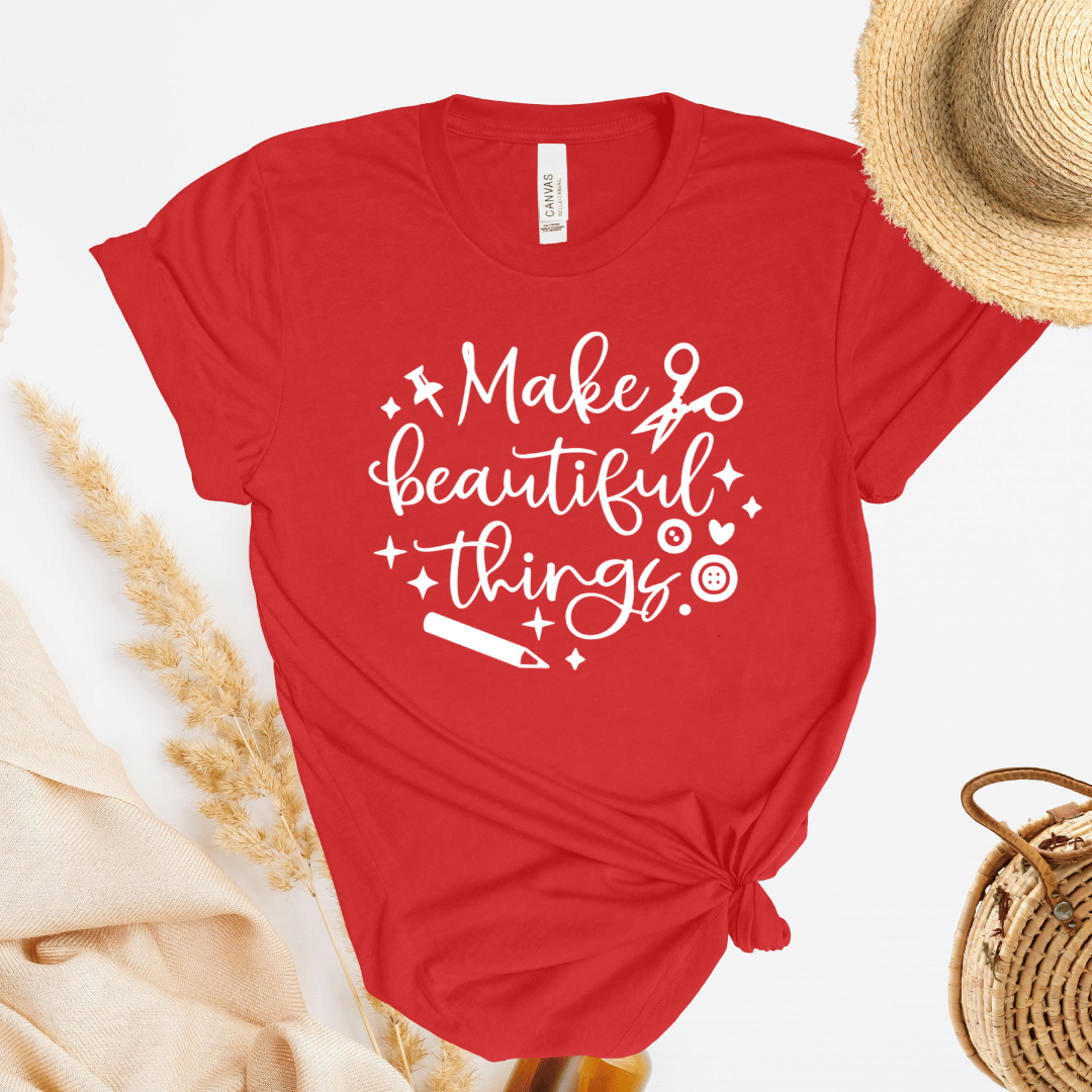 Red t-shirt with 'Make beautiful things' text on a white background