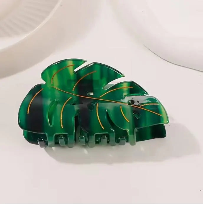 Green leaf-shaped hair clip on a white background