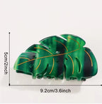 Green leaf-shaped hair clip with measurements on a white background