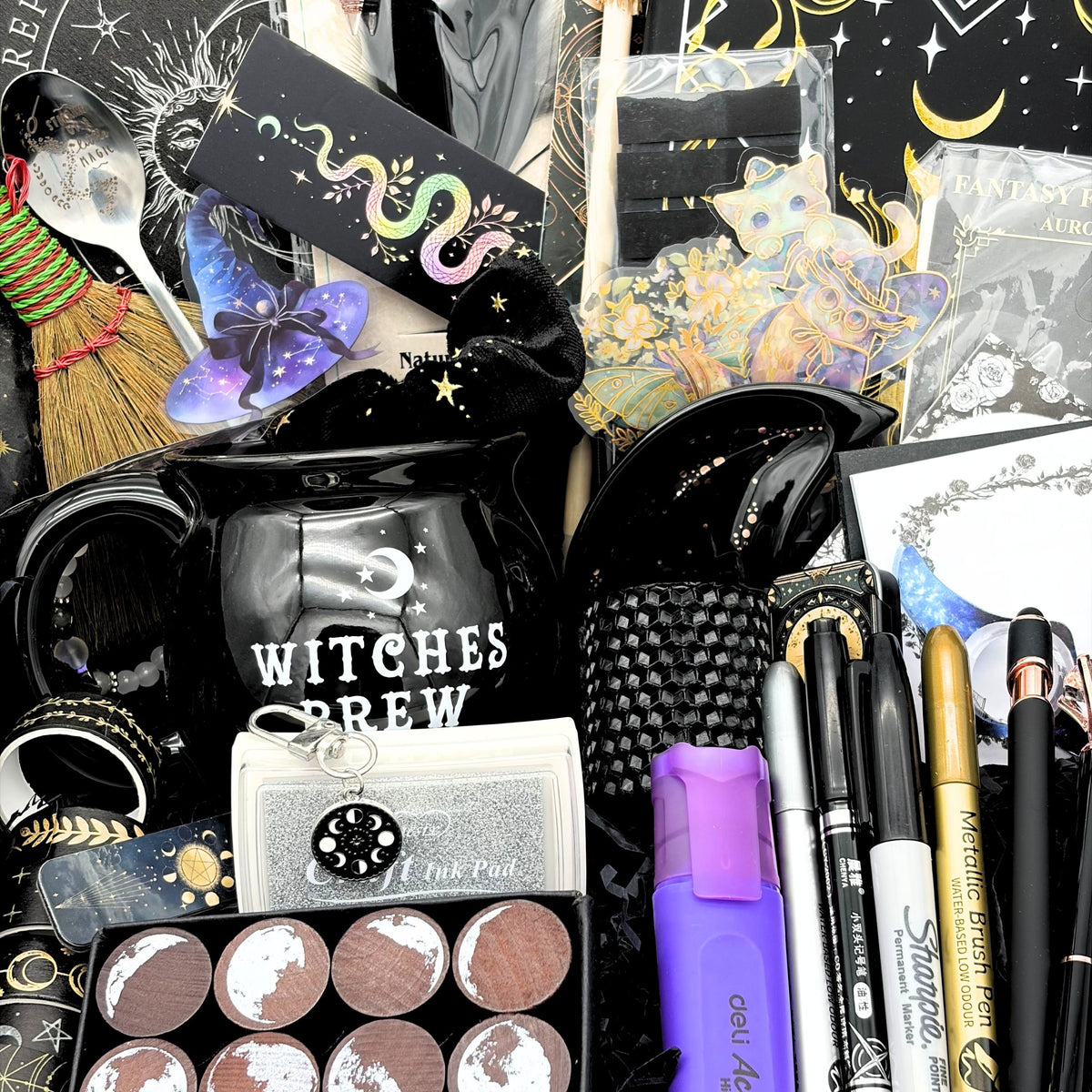 Close view of the mystical witchy gift box contents including the cauldron mug, moon trinket tray, moon phase stamps and washi tape