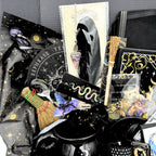 More than 30 pieces of the mystical witchy gift box arranged in black and gold celestial tissue around a witches brew cauldron mug