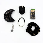 Crescent moon trinket tray, black beeswax candle, cat matchbox, moon phase bracelet, zipper pull and star scrunchie