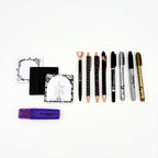 Eight pens and markers from the mystical witchy gift box beside skull and ribcage sticky note pads and a purple highlighter