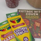 Overhead video of fine line markers, colored pencils, and the Cottage Witch Coven coloring book from the pumpkin gift set