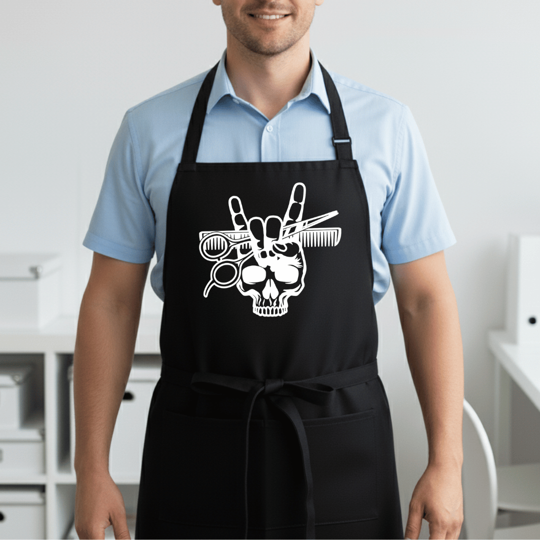 Black professional barber apron with white skull rock hand gesture and styling tools worn by male barber