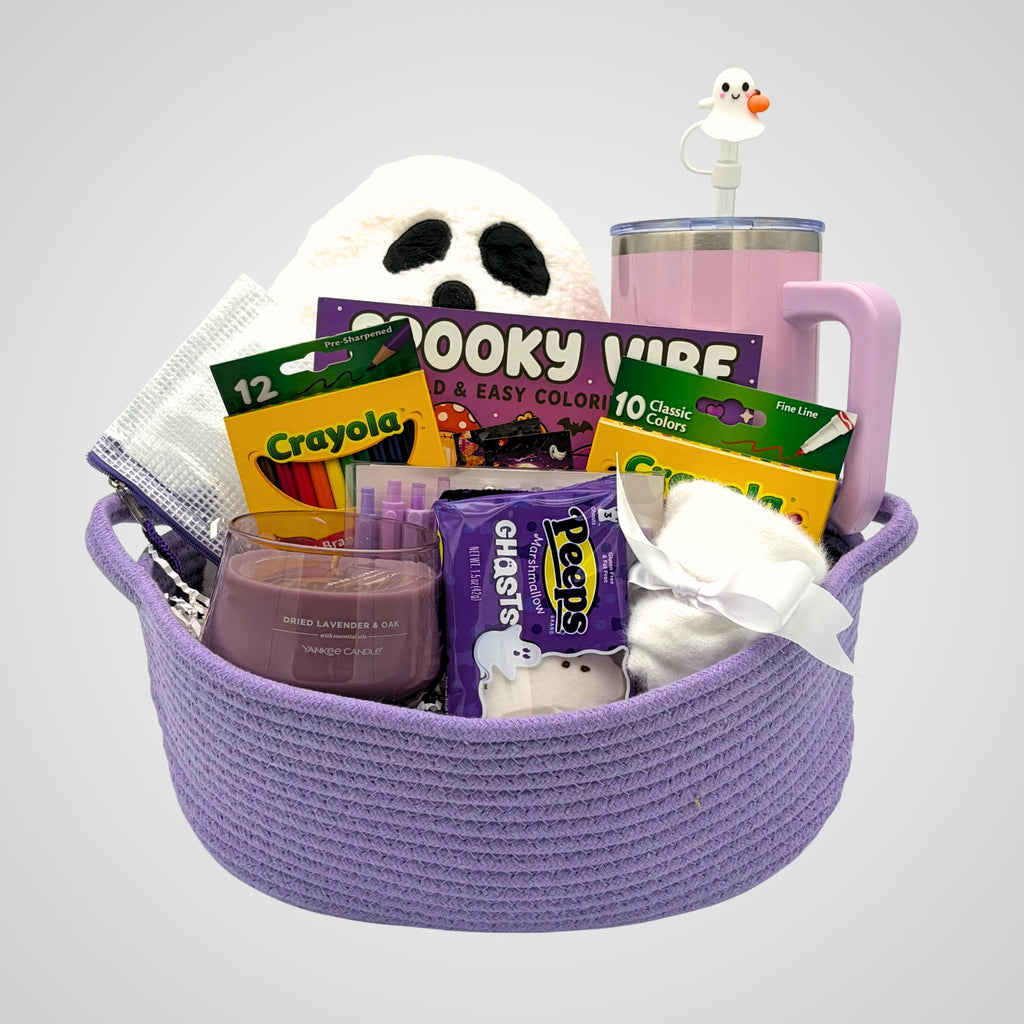 Purple ghost coloring book gift set in a woven purple rope basket with a ghost pillow, tumbler, and coloring supplies on gray
