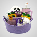 Purple ghost coloring book gift set in a woven purple rope basket with a ghost pillow, tumbler, and coloring supplies on gray