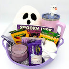 Purple Halloween gift basket filled with a ghost pillow, coloring book, pencils, markers, candle, marshmallow ghosts, and socks