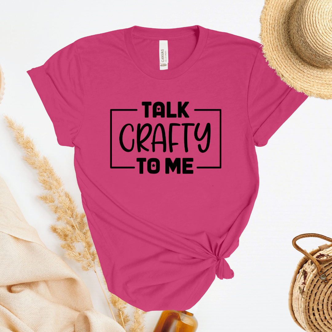 Pink t-shirt with 'Talk Crafty to Me' text on a white background