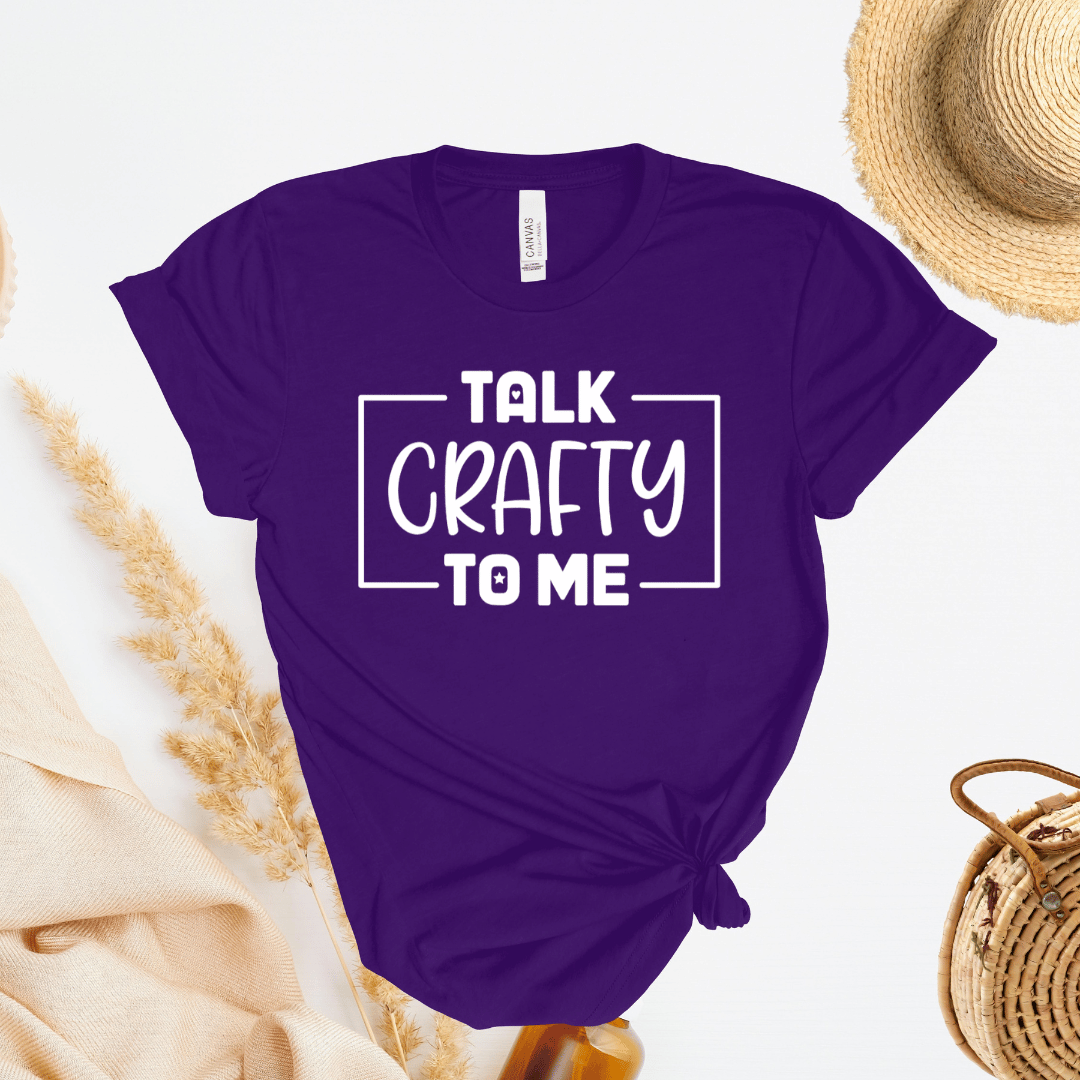 Purple t-shirt with 'Talk Crafty to Me' text on a light background