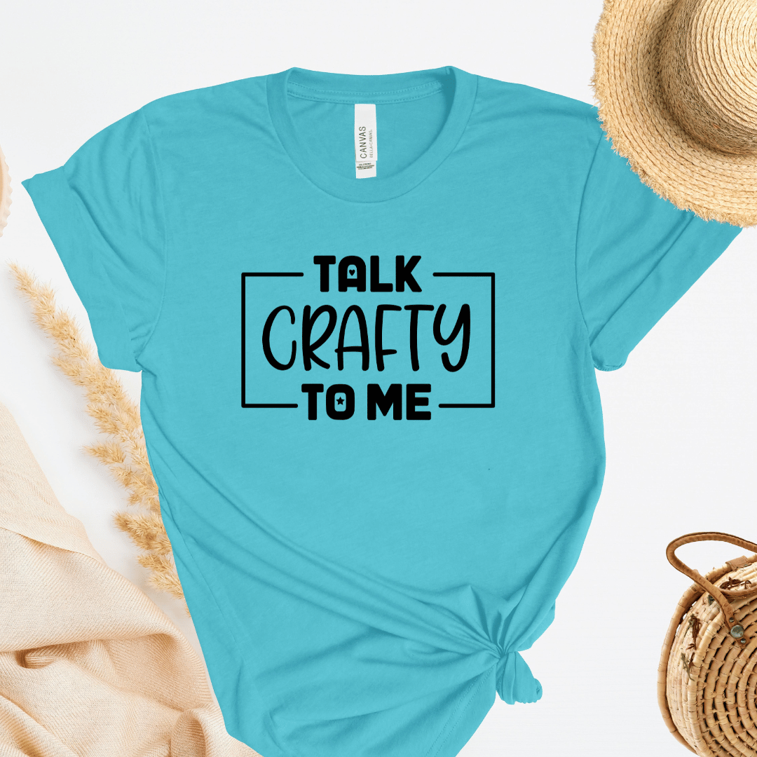 Turquoise t-shirt with 'Talk Crafty to Me' text on a white background
