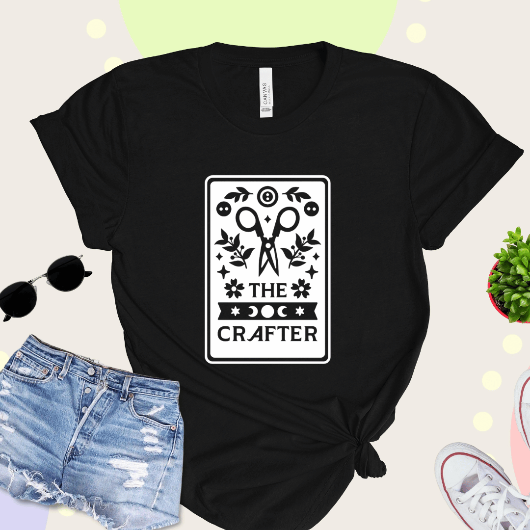 The Crafter tarot card t-shirt in black with scissors, botanicals, and moon phase design
