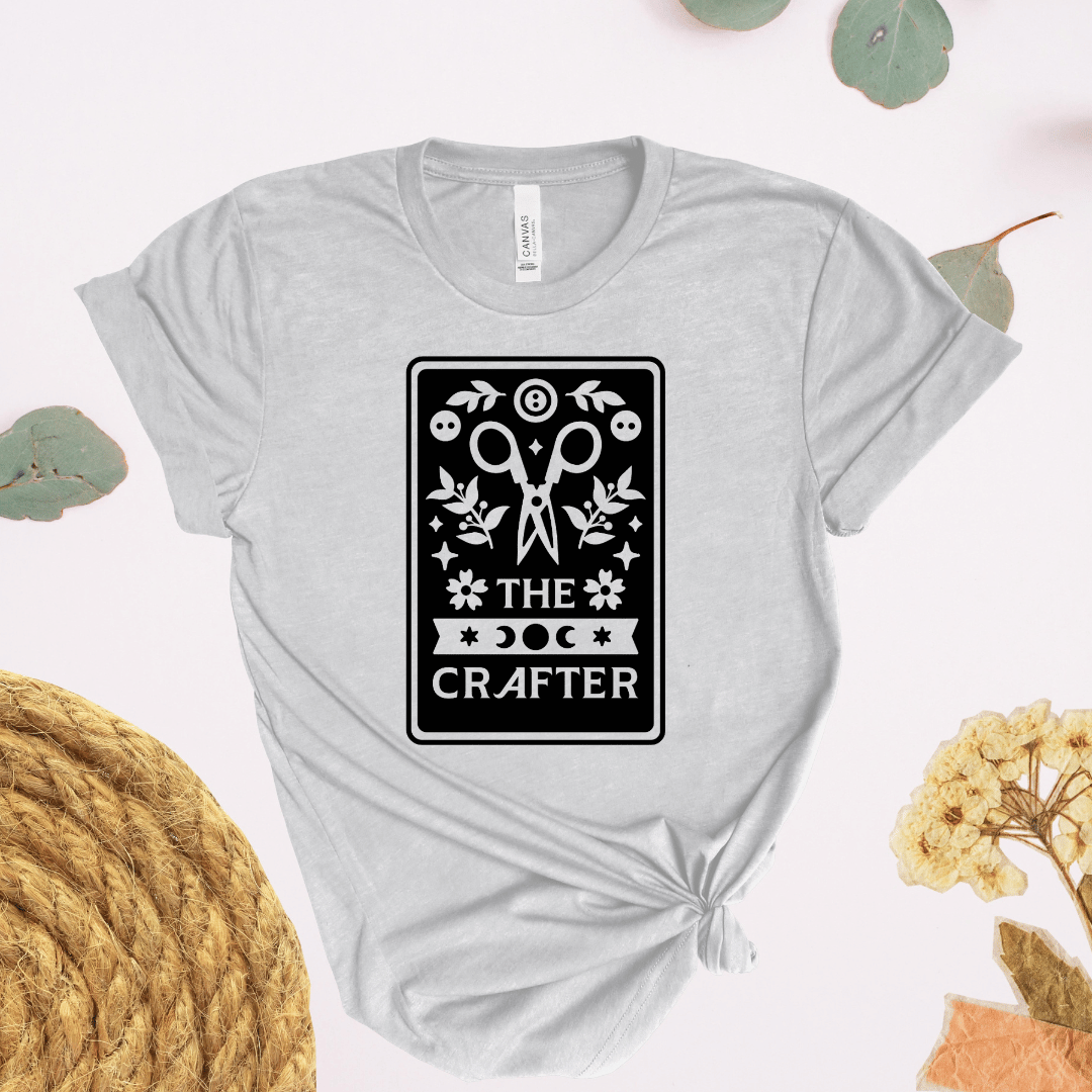The Crafter tarot card t-shirt in light gray with scissors, botanicals, and moon phase design