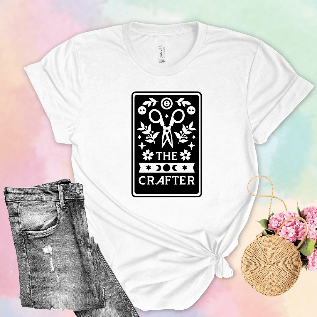 The Crafter tarot card t-shirt in white with scissors, botanicals, and moon phase design